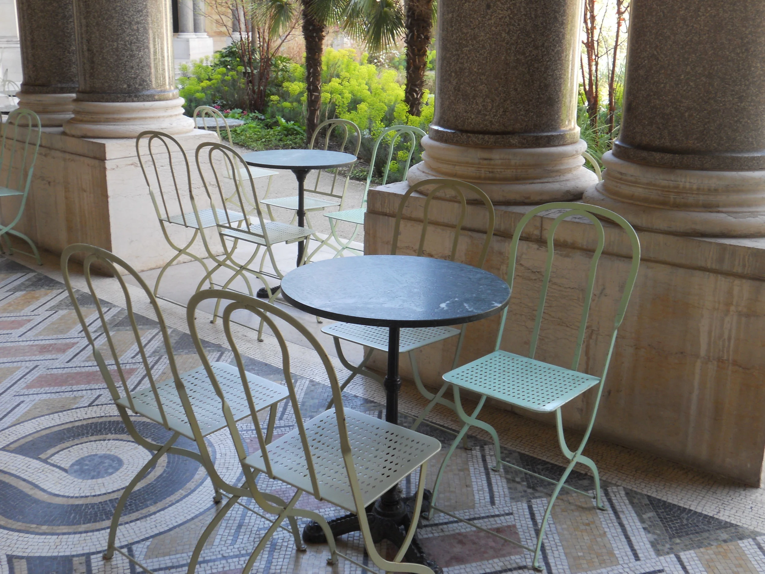Bistro seating outside museum cafe overlooks garden